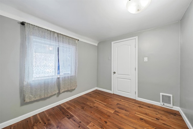 spare room featuring wood-type flooring