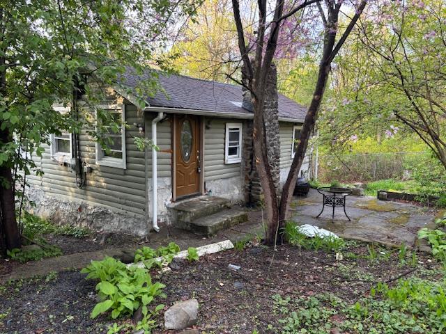16 Stanton Trl, Monroe, NY 10950 - view of front of house with a patio and a shingled roof