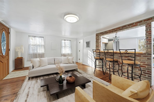 16 Stanton Trl, Monroe, NY 10950 - living room featuring wood finished floors, a bar, baseboards, and brick wall