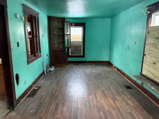 spare room featuring dark wood-type flooring