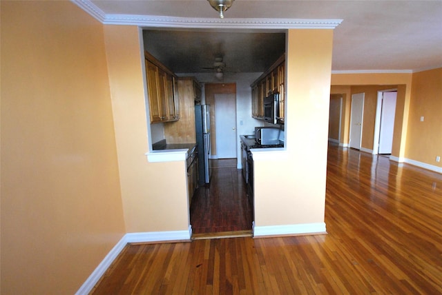 kitchen with crown molding, ceiling fan, appliances with stainless steel finishes, and dark hardwood / wood-style floors