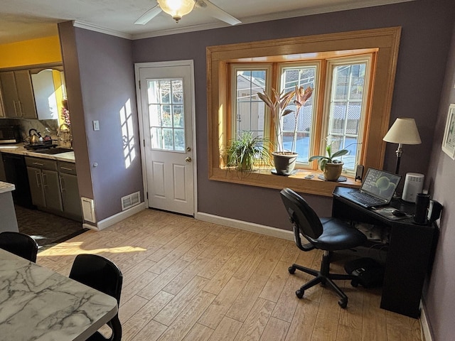 home office featuring ornamental molding, plenty of natural light, sink, and light hardwood / wood-style floors