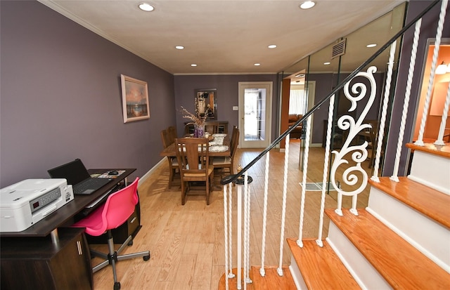 office space with crown molding and light wood-type flooring