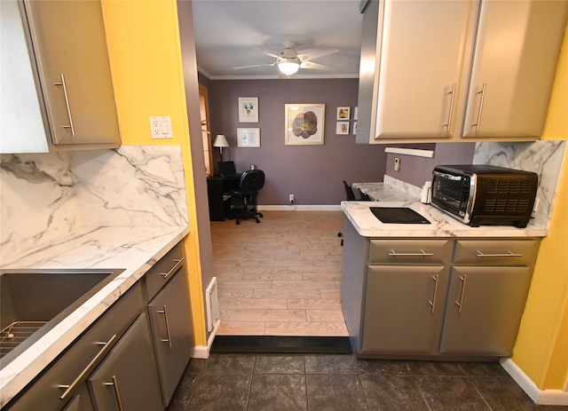 kitchen with ceiling fan, ornamental molding, sink, and gray cabinetry