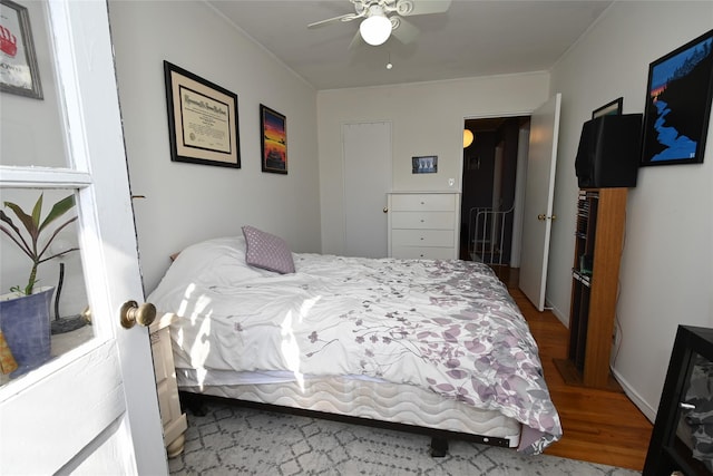 bedroom with ceiling fan and wood-type flooring