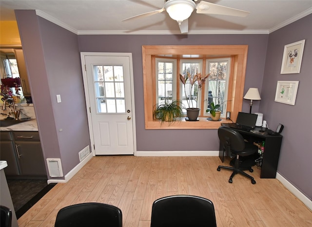 office space featuring ceiling fan, ornamental molding, and light hardwood / wood-style flooring