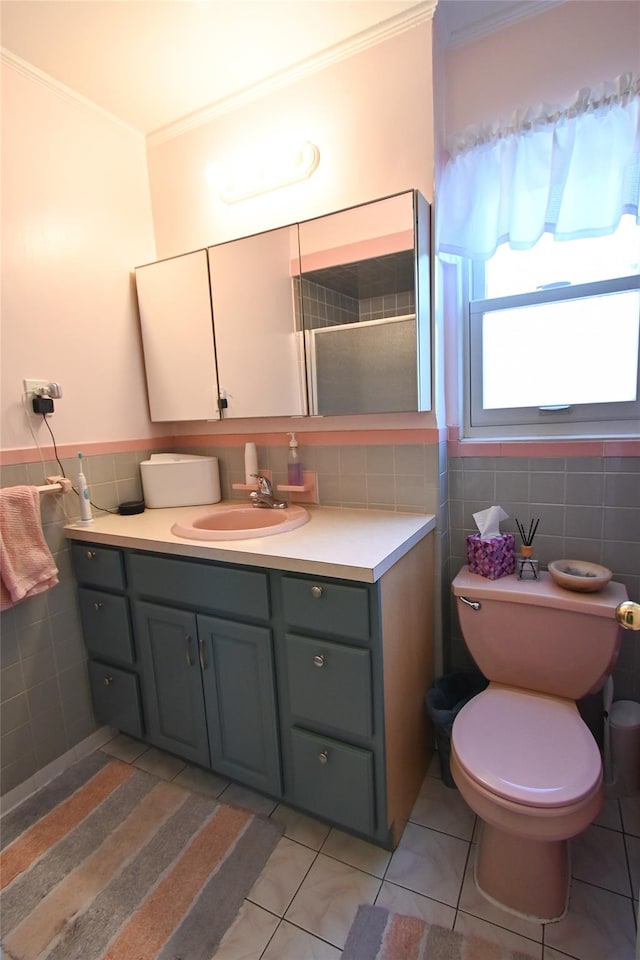 bathroom with crown molding, tile walls, tile patterned floors, and vanity