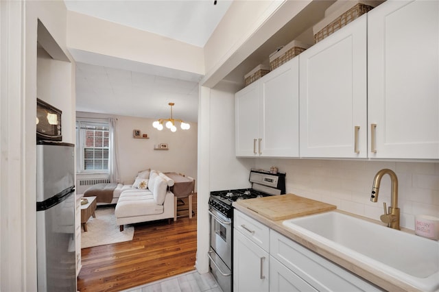 kitchen with white cabinetry, appliances with stainless steel finishes, and sink