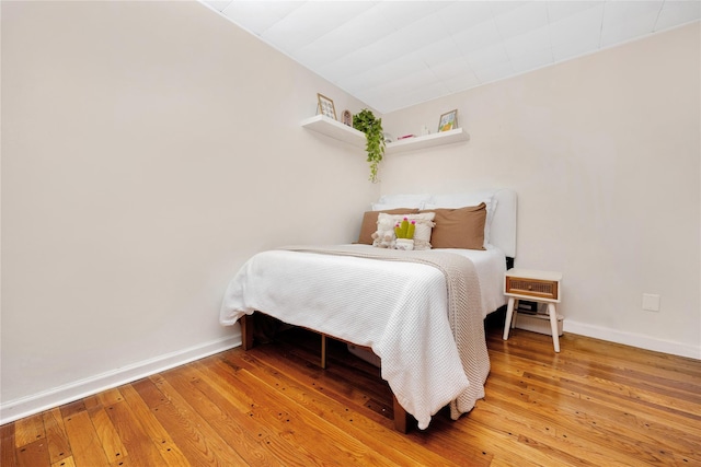 bedroom with hardwood / wood-style floors