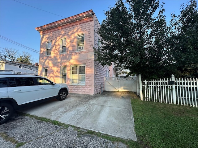 view of side of home with a lawn