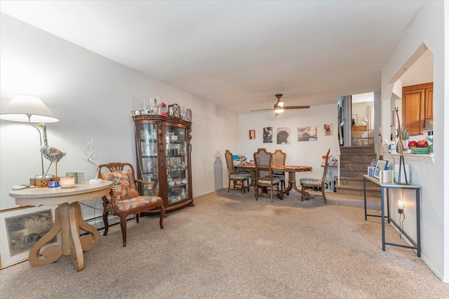 dining room with light carpet and ceiling fan