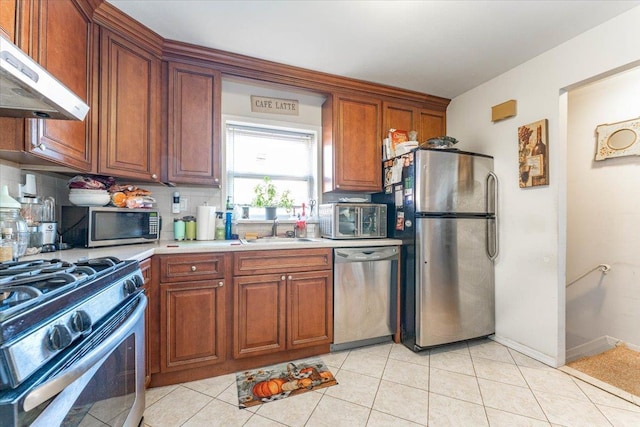 kitchen featuring tasteful backsplash, stainless steel appliances, light tile patterned flooring, and sink