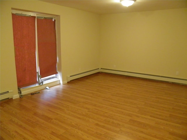 spare room with light hardwood / wood-style flooring and a baseboard heating unit