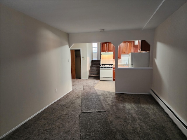 unfurnished living room with light colored carpet, sink, and a baseboard heating unit