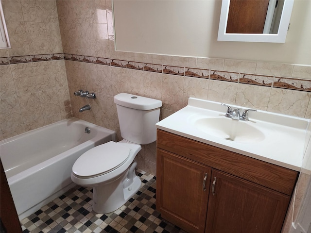 full bathroom featuring tile walls, tiled shower / bath combo, vanity, toilet, and tile patterned floors