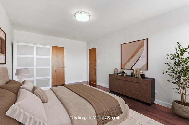 bedroom featuring dark wood-style floors and baseboards