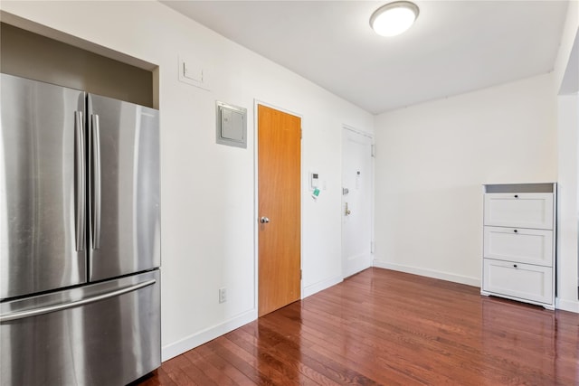 kitchen with freestanding refrigerator, dark wood-style flooring, and baseboards