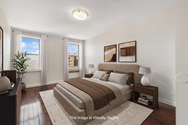 bedroom with radiator, baseboards, and dark wood finished floors