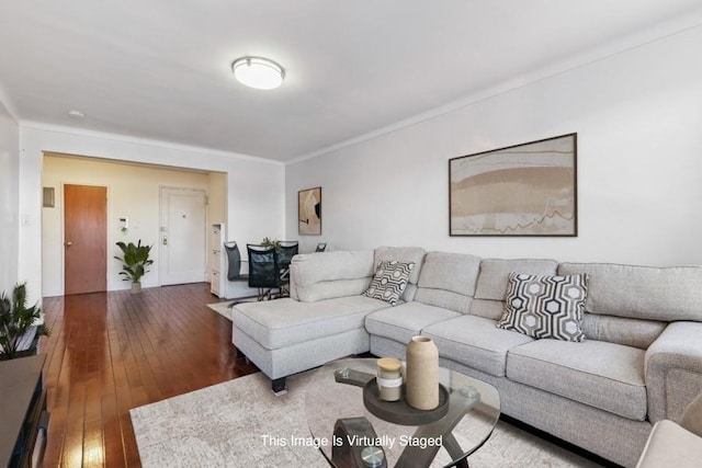 living area with dark wood-type flooring and crown molding