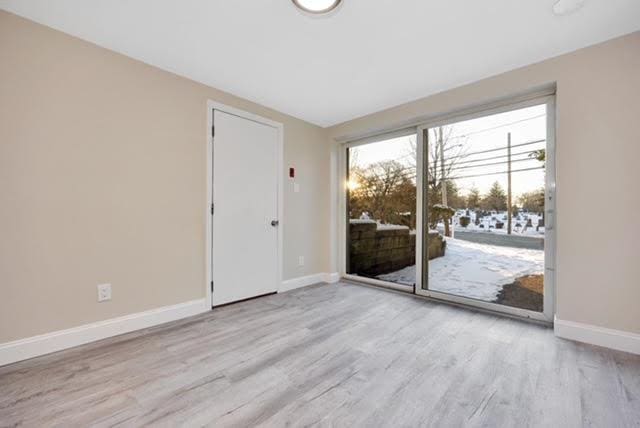 spare room with light wood-type flooring