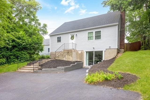 122 Vernon Valley Rd, East Northport, NY 11731 - back of house featuring a chimney
