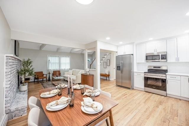 122 Vernon Valley Rd, East Northport, NY 11731 - living room with stairs, light wood-style flooring, a fireplace, and recessed lighting