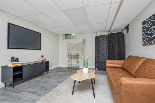 122 Vernon Valley Rd, East Northport, NY 11731 - living room with wood finished floors and a drop ceiling