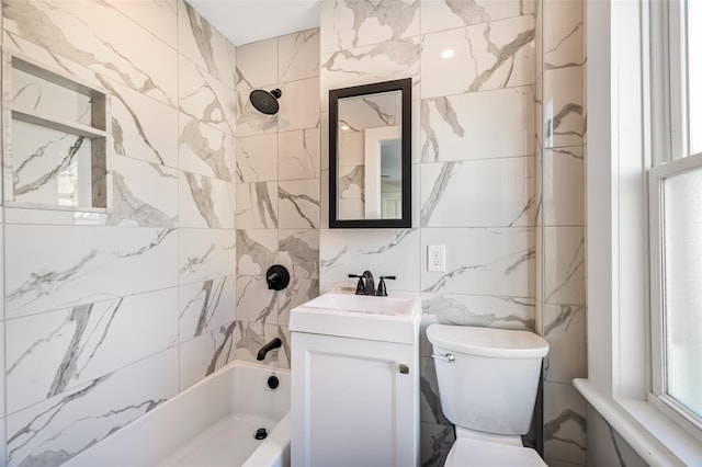 full bathroom with vanity, tile walls, toilet, and shower / bath combination