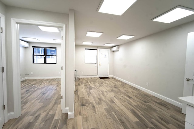 interior space featuring dark hardwood / wood-style floors and a wall unit AC