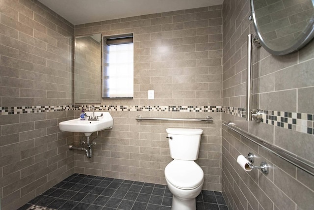 bathroom featuring sink, tile walls, tile patterned floors, and toilet