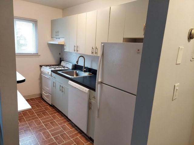 kitchen with white cabinetry, white appliances, sink, and decorative backsplash