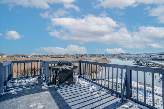 wooden deck featuring a water view and area for grilling