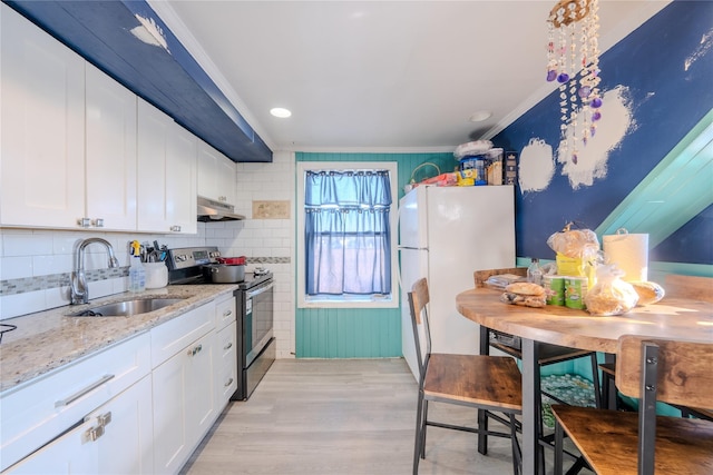 kitchen with white refrigerator, white cabinets, sink, and electric range