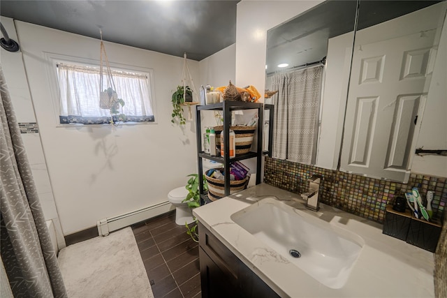 bathroom featuring toilet, tasteful backsplash, a baseboard radiator, vanity, and tile patterned flooring