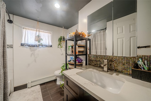 full bathroom featuring shower / tub combo with curtain, tasteful backsplash, a baseboard radiator, vanity, and toilet