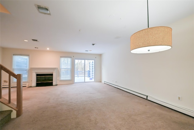 unfurnished living room with a baseboard radiator and light colored carpet