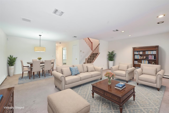 living room featuring a baseboard radiator and light colored carpet