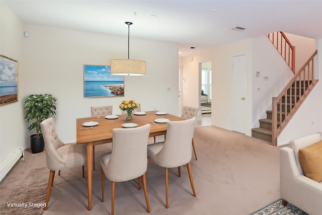 dining area featuring a baseboard heating unit and carpet flooring