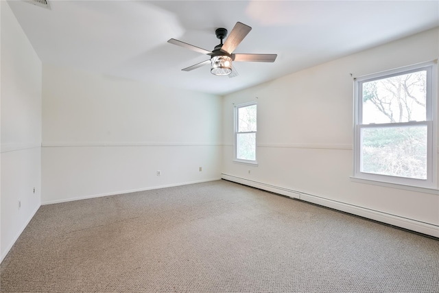 carpeted spare room with a baseboard heating unit and ceiling fan