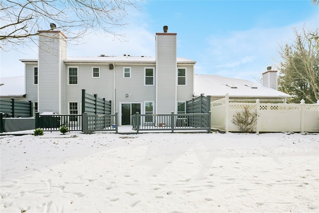 snow covered property featuring a wooden deck