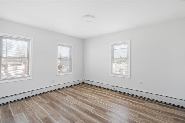 spare room with light hardwood / wood-style floors and a wealth of natural light