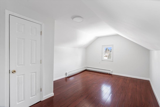 bonus room with dark hardwood / wood-style flooring and vaulted ceiling