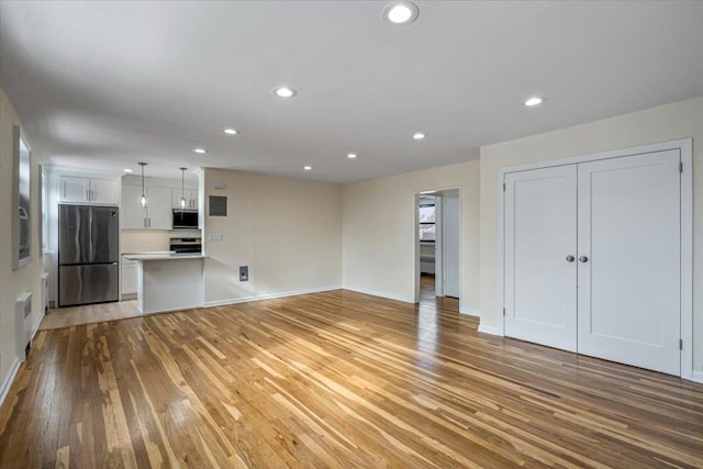 unfurnished living room featuring light hardwood / wood-style floors