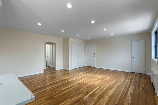 unfurnished living room with dark hardwood / wood-style flooring