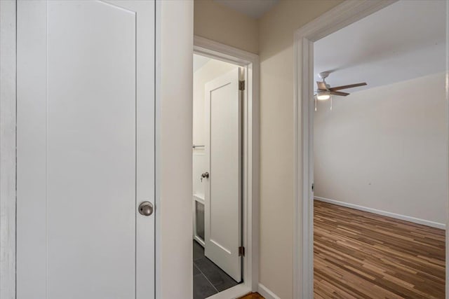 hallway with dark hardwood / wood-style flooring