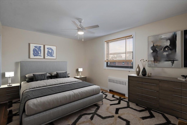 bedroom featuring radiator, ceiling fan, and light hardwood / wood-style floors