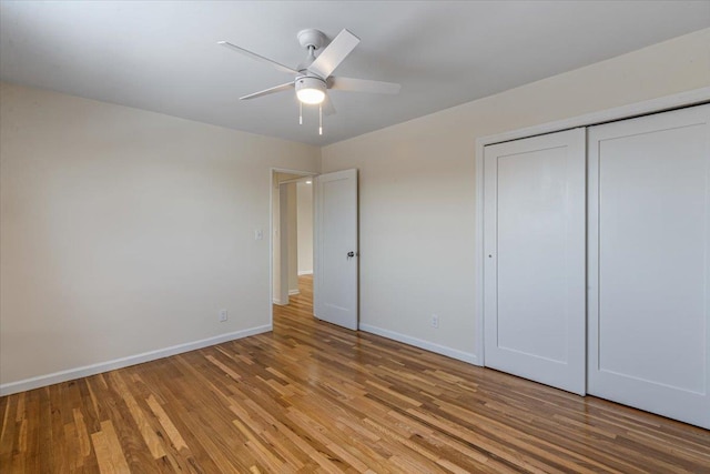 unfurnished bedroom featuring ceiling fan, a closet, and light hardwood / wood-style flooring