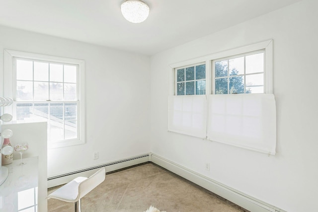 unfurnished room featuring a baseboard radiator and light carpet