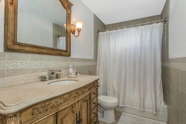 full bathroom with shower / tub combo with curtain, vanity, toilet, and tile walls