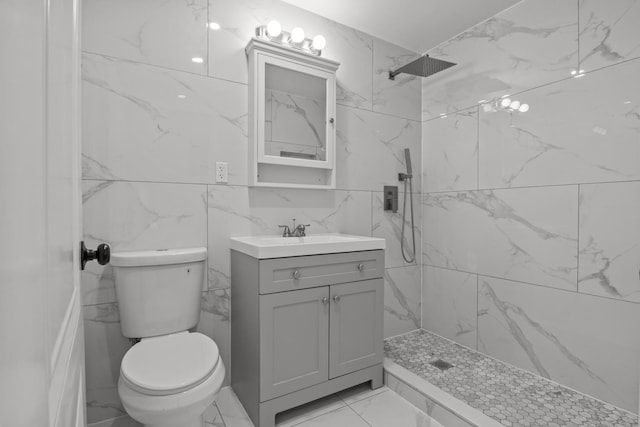 bathroom featuring vanity, tiled shower, and toilet